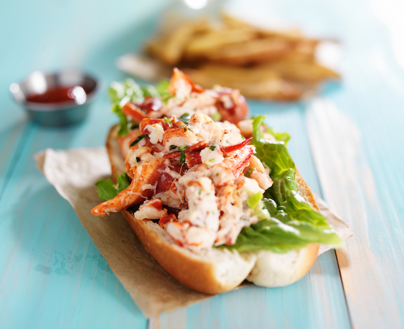 Lobster roll on a teal wooden table